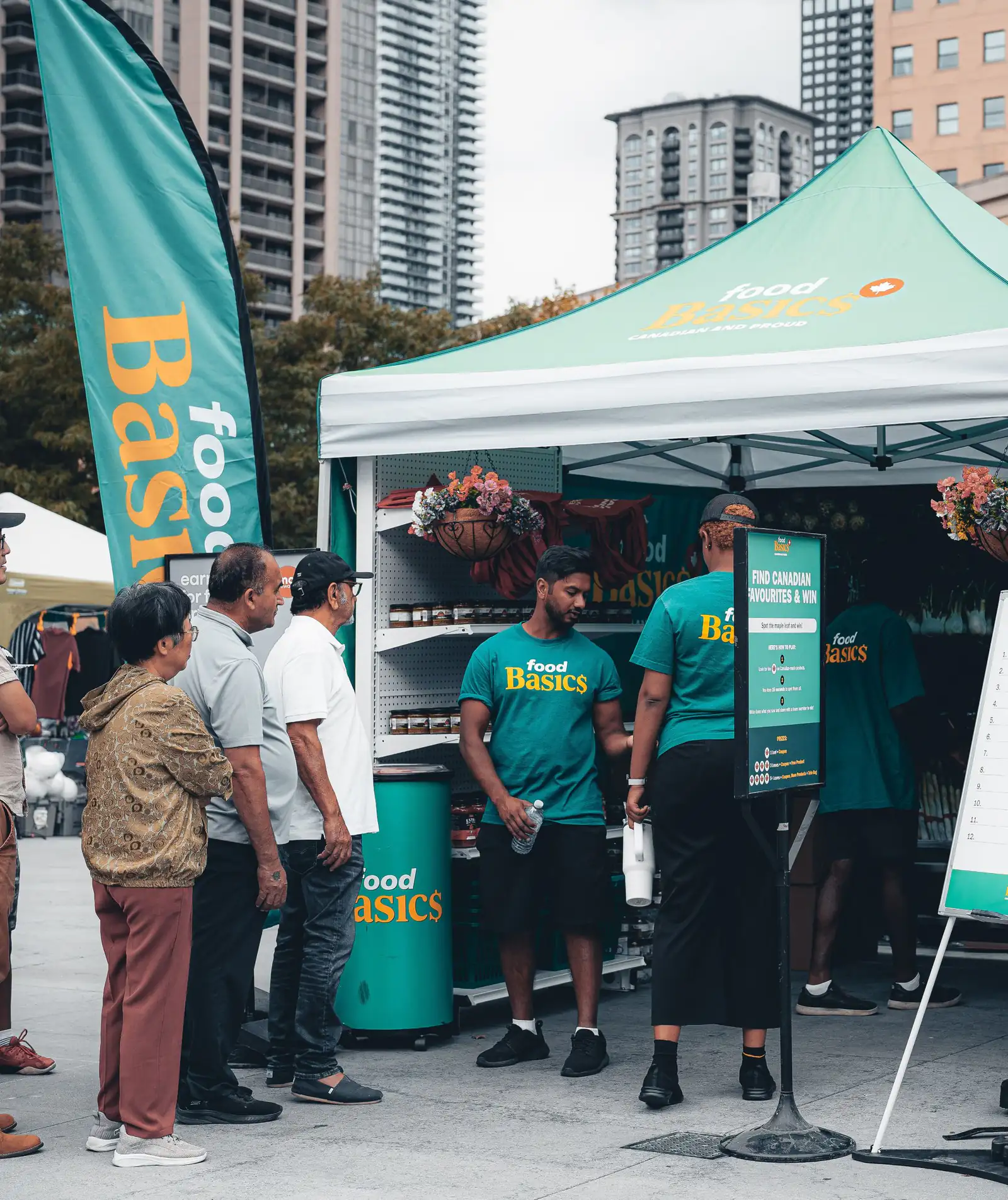 People gathered around a booth at an outdoor community festival in Mississauga